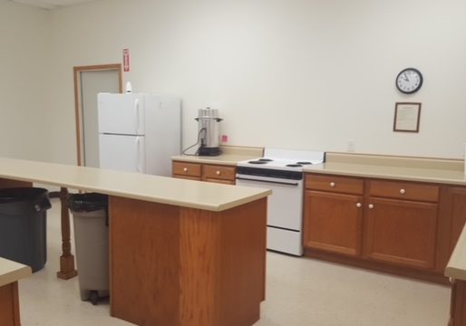 Spacious kitchen with appliances and wooden cabinets.